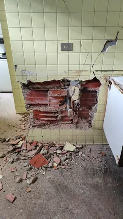 Kitchen wall damage connecting to the main bathroom view 2